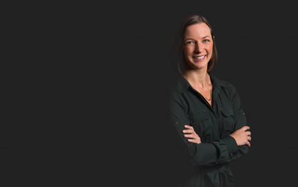 Susan DuMont is smiling and wearing a black dress.