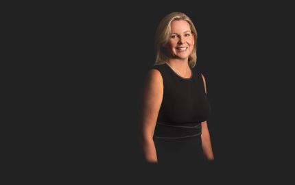 Nancy Whiteman Greene is smiling and wearing a black dress.