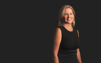 Nancy Whiteman Greene is smiling and wearing a black dress.