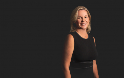 Nancy Whiteman Greene is smiling and wearing a black dress.