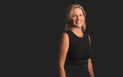 Nancy Whiteman Greene is smiling and wearing a black dress.