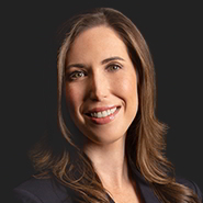 Laura Golden Liff is smiling, wearing a black jacket, and a white shirt. Close up on face.
