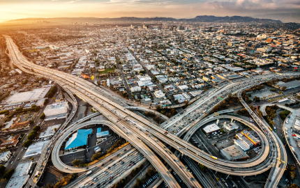 Arial view of freeway interchange in a city.