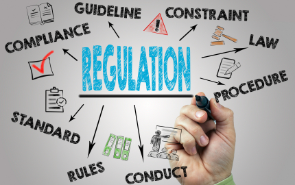 A brainstorm from the word regulation. A hand with a marker preparing to write ideas.