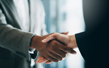 Shaking hands at a merger agreement
