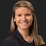 Elisabeth Koloup Hall is smiling, wearing a black jacket, and black shirt. Close up on face.