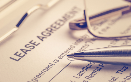 Pen and glasses on a lease agreement form