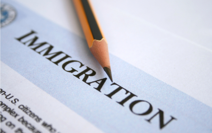Close-up of an immigration form with a pencil on top.