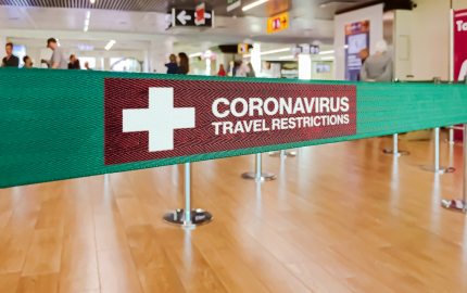 Line rope that says coronavirus travel restrictions