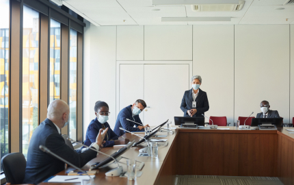 Business people in conference room working in masks