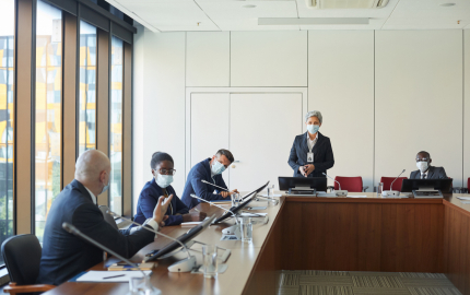 Business people in conference room working in masks