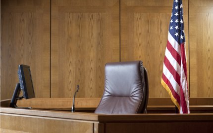 An empty judge's bench with U.S. flag on a flagpole