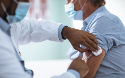 Medical professional giving a person a vaccine.