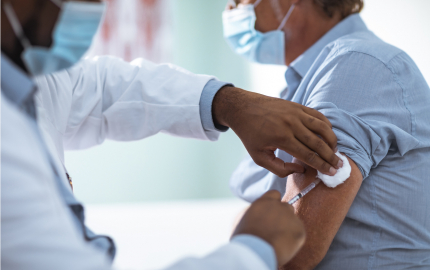 Medical professional giving a person a vaccine.