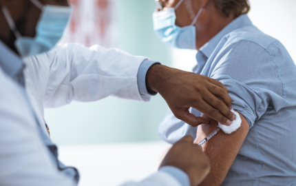 Medical professional giving a person a vaccine.