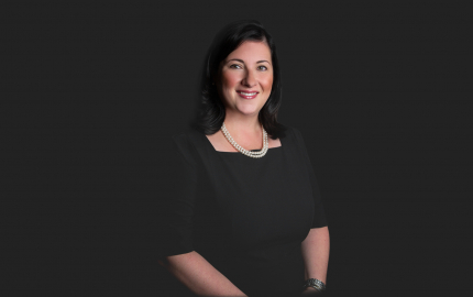 Celia Van Lenten is smiling and wearing a black dress.