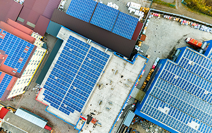 Rooftops with solar panels attached to them.