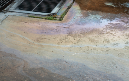 Chemicals on the ground next to a drain.