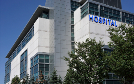 Outside of a hospital with trees.
