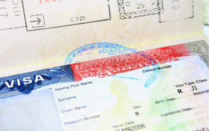 Top of a United States Visa that is stamped.