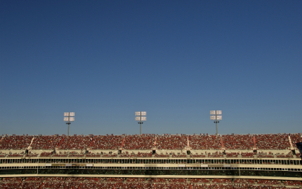 One side of the upper deck of a stadium filled with spectators.