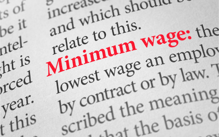 Close up of article with the words minimum wage in red.